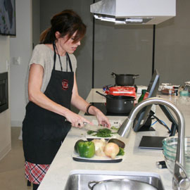 烹饪课老师林赛·沙兹利在示范厨房里切香菜丁